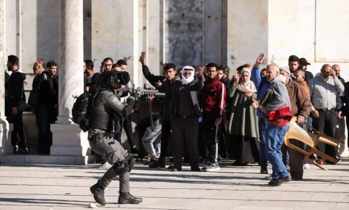 israel-sodier-want-soot-palestinan-people An Israeli security forces member during clashes with Palestinians at the al-Aqsa compound. Photograph: Ammar Awad/Reuters