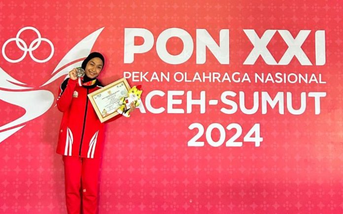 Novriza Raihanda Novriza Raihanda, Gadis Bireuen yang Bersinar Raih Perak Wushu PON XXI Novriza Raihanda raih medali perak cabor wushu nomor sanda 48 kg putri. Foto: Komparatif.ID/Rahmad Bugak.