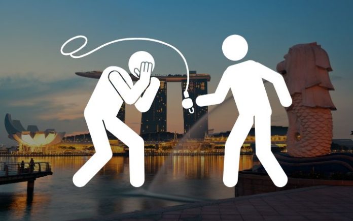 Singapura Pertimbangkan Adopsi Hukuman Cambuk bagi Pelaku Penipuan Pemerintah Singapura mempertimbangkan hukuman cambuk bagi pelaku penipuan seiring meningkatnya kasus kejahatan siber. Ilustrasi: Komparatif.ID.